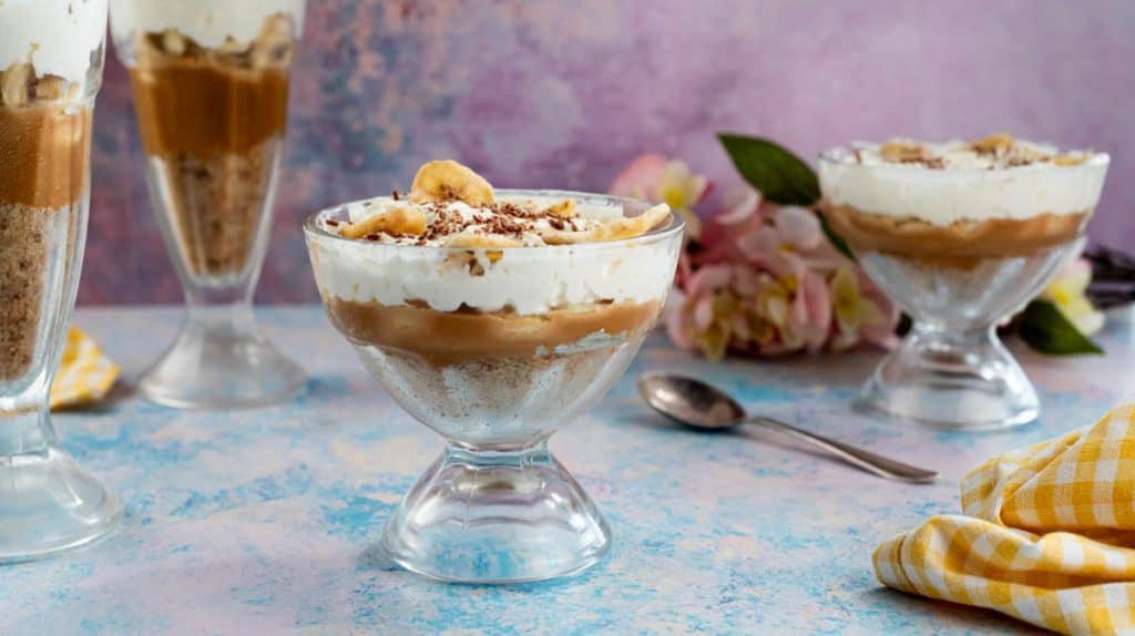 Front view on Banoffee cups in a glass container.
