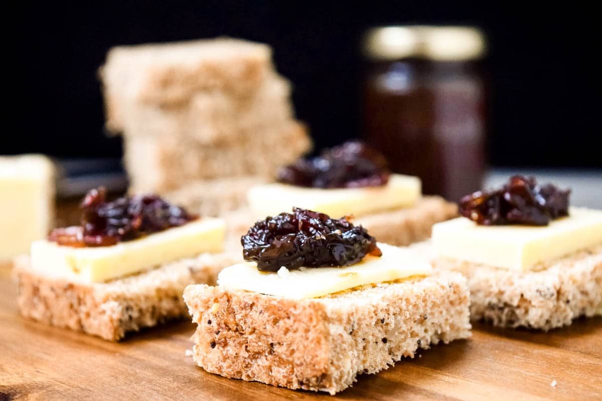 Onion Chutney on top of sliced bread and cheese.