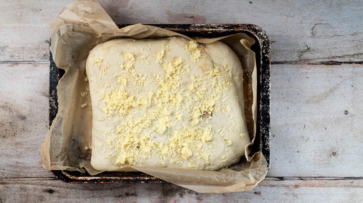 The unbaked cheese and Marmite loaf after it has been allowed to rise for two hours inside a baking tin.