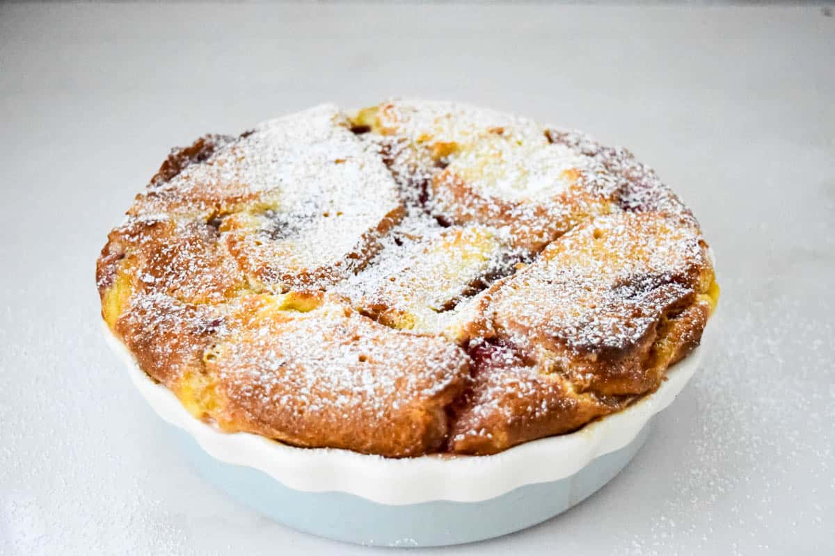 A front view of a doughnut bread pudding in a bowl.
