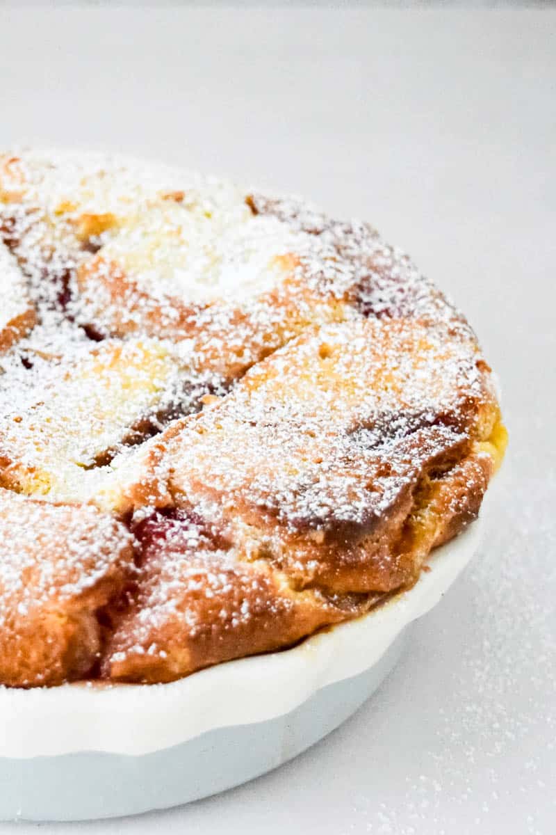 A close-up of the side on a dish containing doughnut pudding.