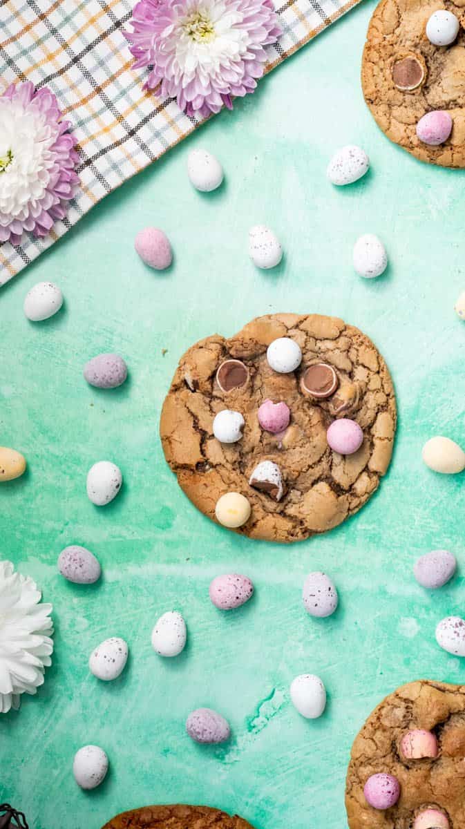 Mini Eggs biscuits on a flat surface surrounded by mini eggs.
