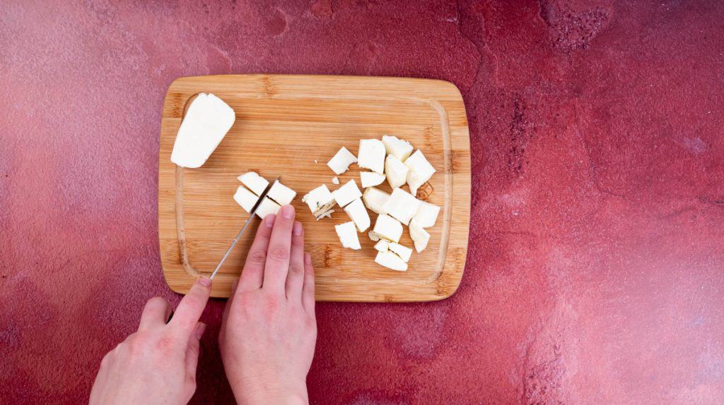 I had this using a sharp knife to cut a halloumi piece into cubes on top of a wooden board.