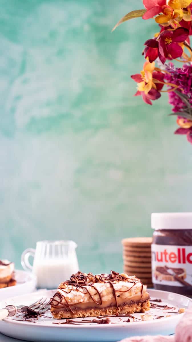A slice of Nutella Banoffee pie on a white plate with a fork.